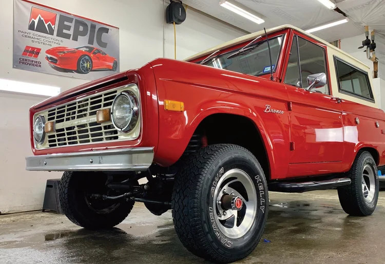 Vintage red Ford Bronco detailed in the shop
