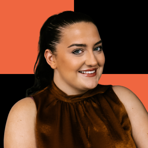 Portrait of a young woman with dark hair, smiling, wearing a sleeveless brown top, with a background of orange and black blocks.