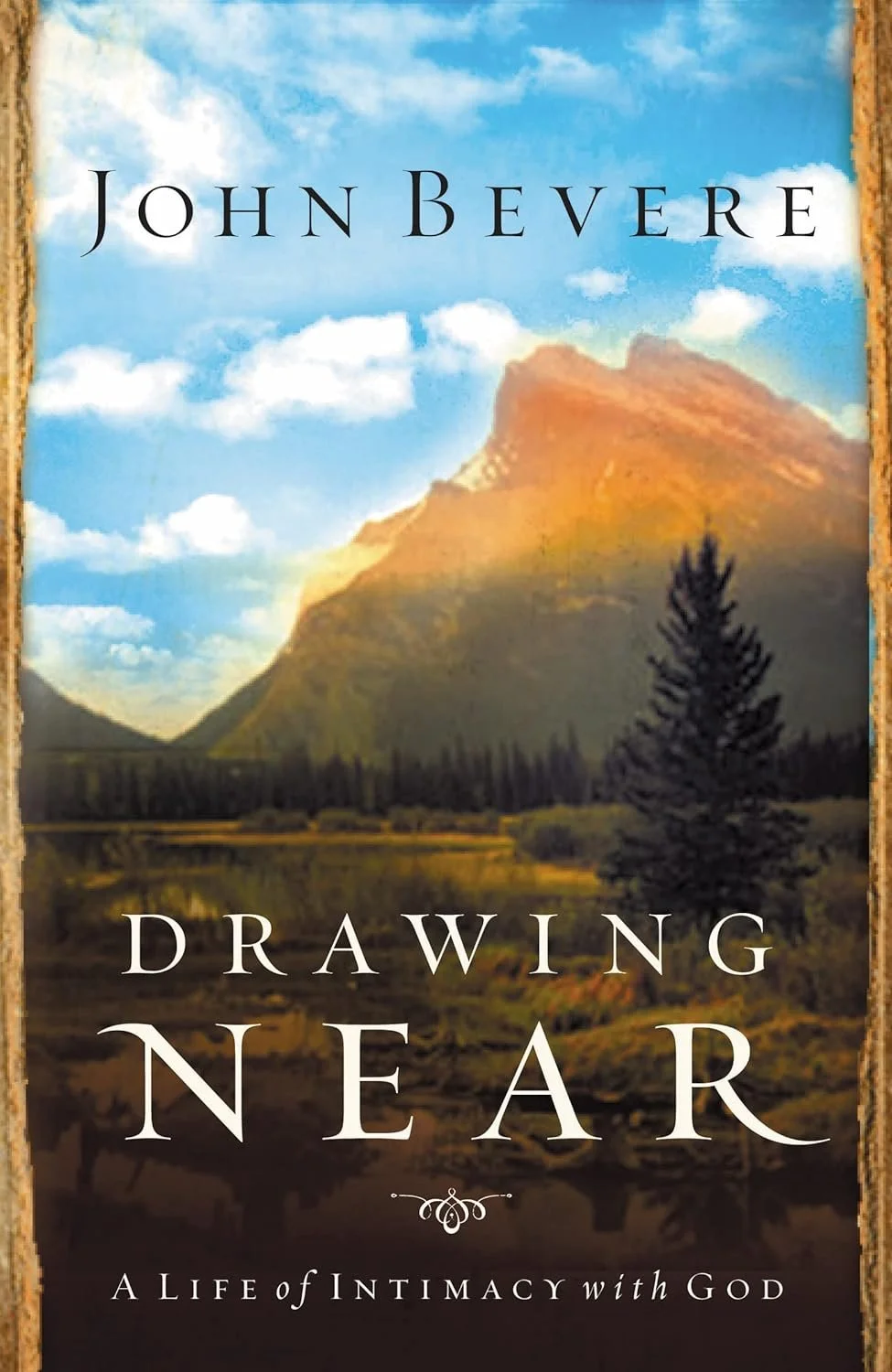 Book cover for 'Drawing Near' by John Bevere, featuring a landscape with a mountain, trees, and a cloudy sky.
