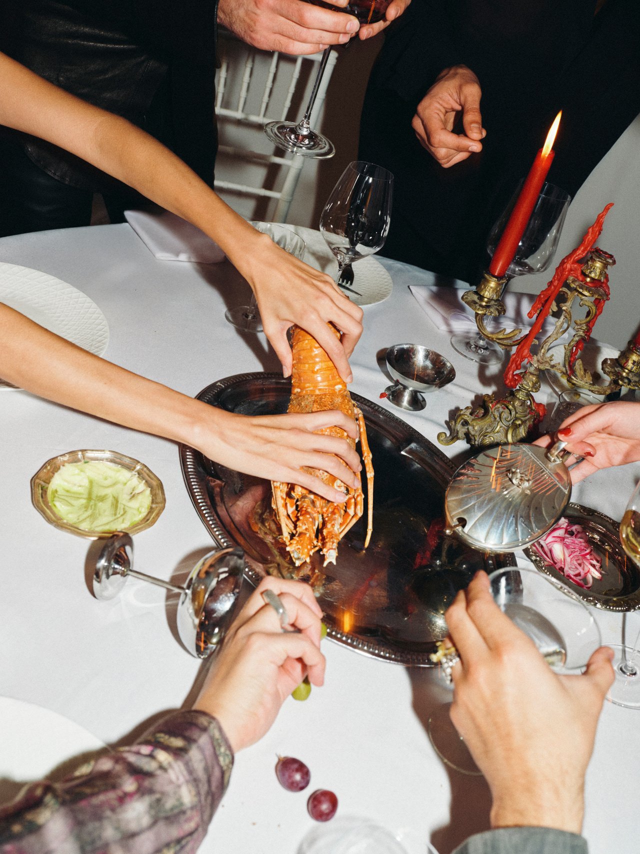 Guests sharing lobster at a Feast with Fiore private chef dinner in Los Angeles.