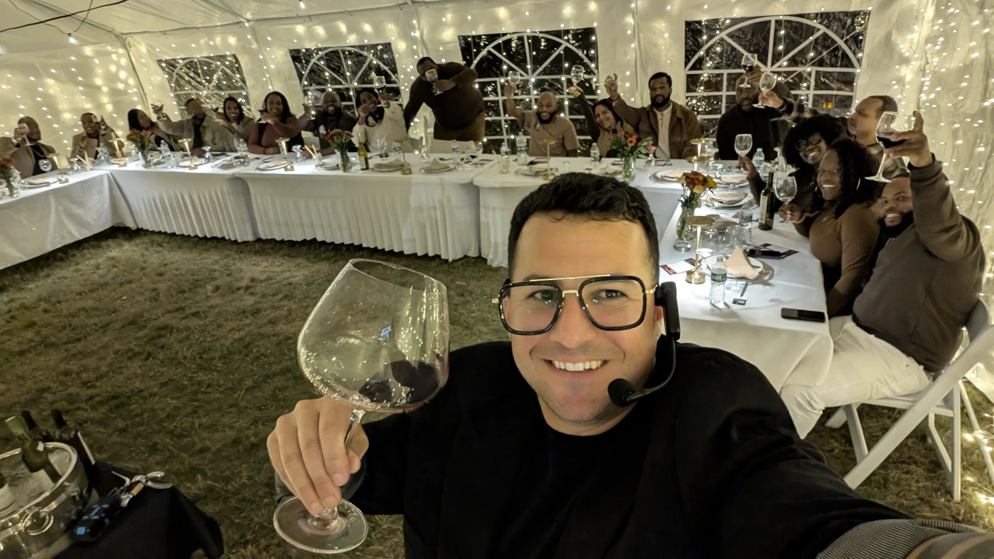 Angel Ramón Crespo with guests at a lit tent wine tasting event