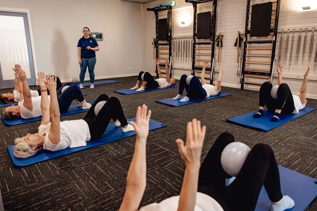 happy student in a mat pilates class