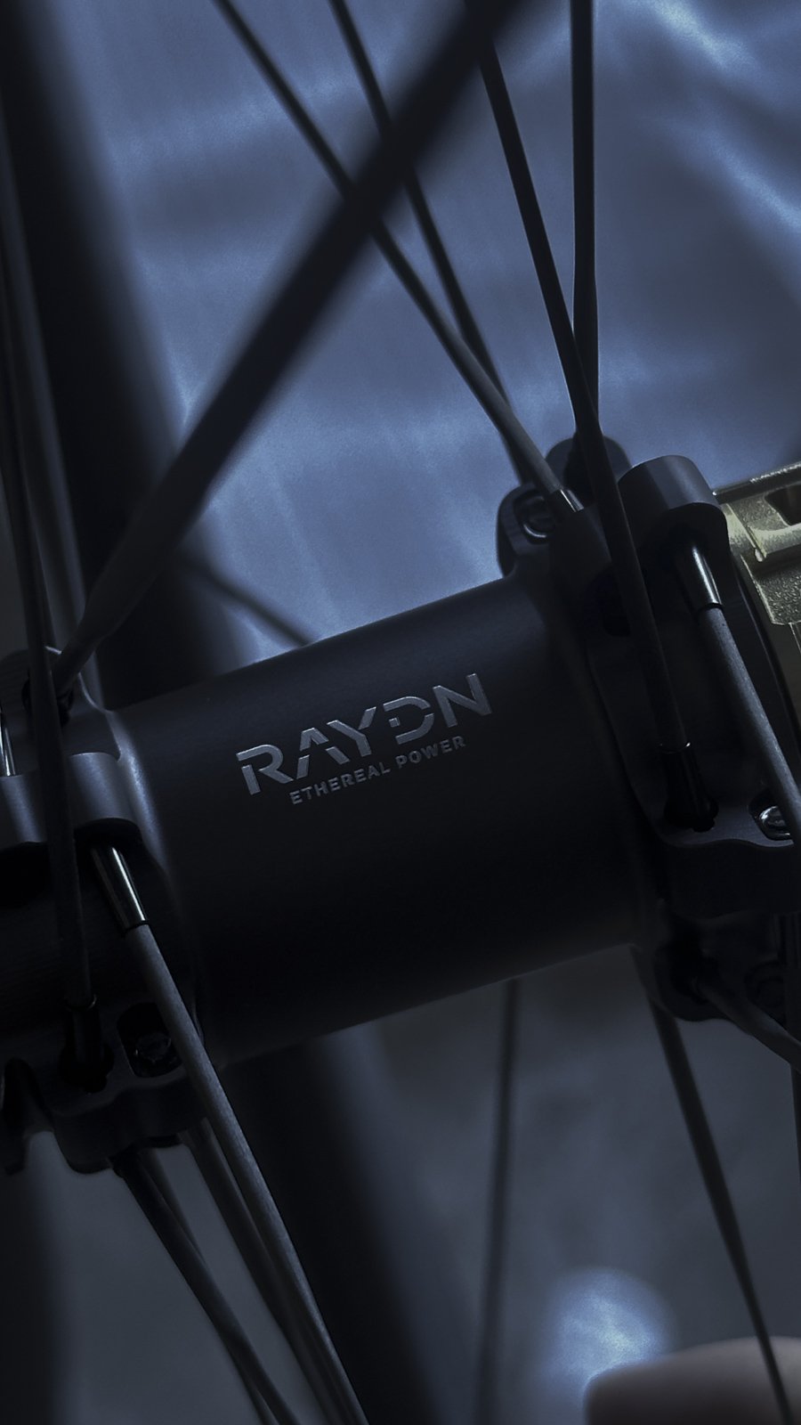 Close-up of a RAYON ETHEREAL POWER 7075 aluminium bicycle hubs with visible carbob spokes