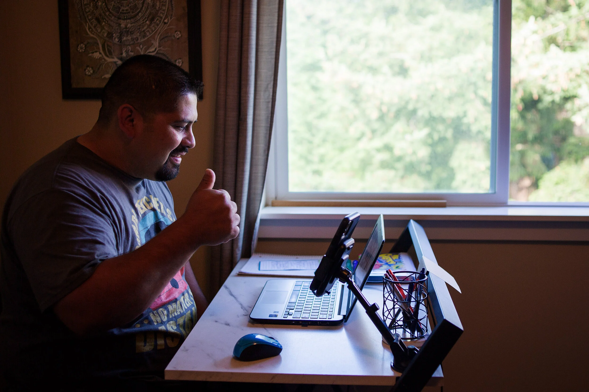 Adan Rodriguez, a third grade teacher at Madison Elementary, gives a thumbs up to students during the first moments of class on the first day of school on on Sept. 2, 2020 in Mount Vernon, Wash. After a couple test runs the night before, Rodriguez s