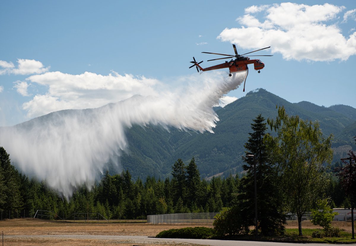  A helicopter used to fight the Sourdough Fire performs a dust abatement before landing at base camp on Aug. 1 in Concrete.  