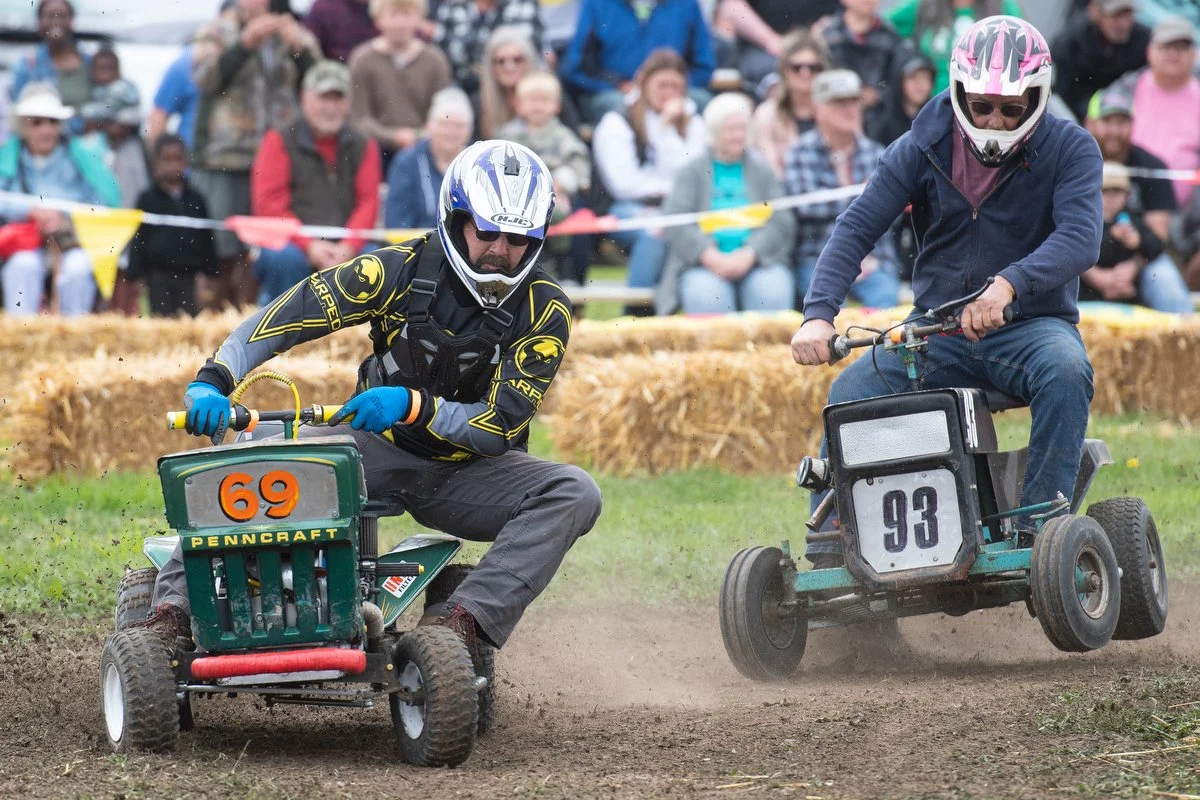  Drivers race their lawnmowers around the track on June 17 during the Berry Dairy Days Lawnmower Races in Burlington. 