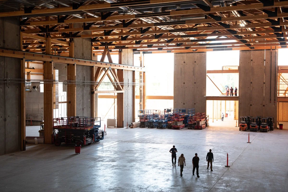  People walk through the nearly-finished Janicki Industries aerospace manufacturing building on June 2 during an open house in Hamilton. 