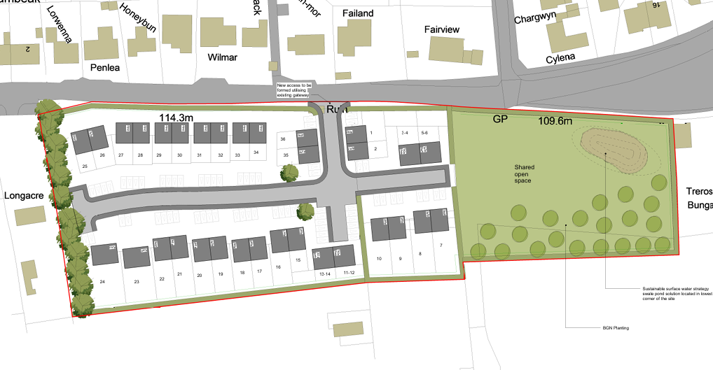 Site plan of a residential development with housing units, parking areas, and a shared open space with trees.