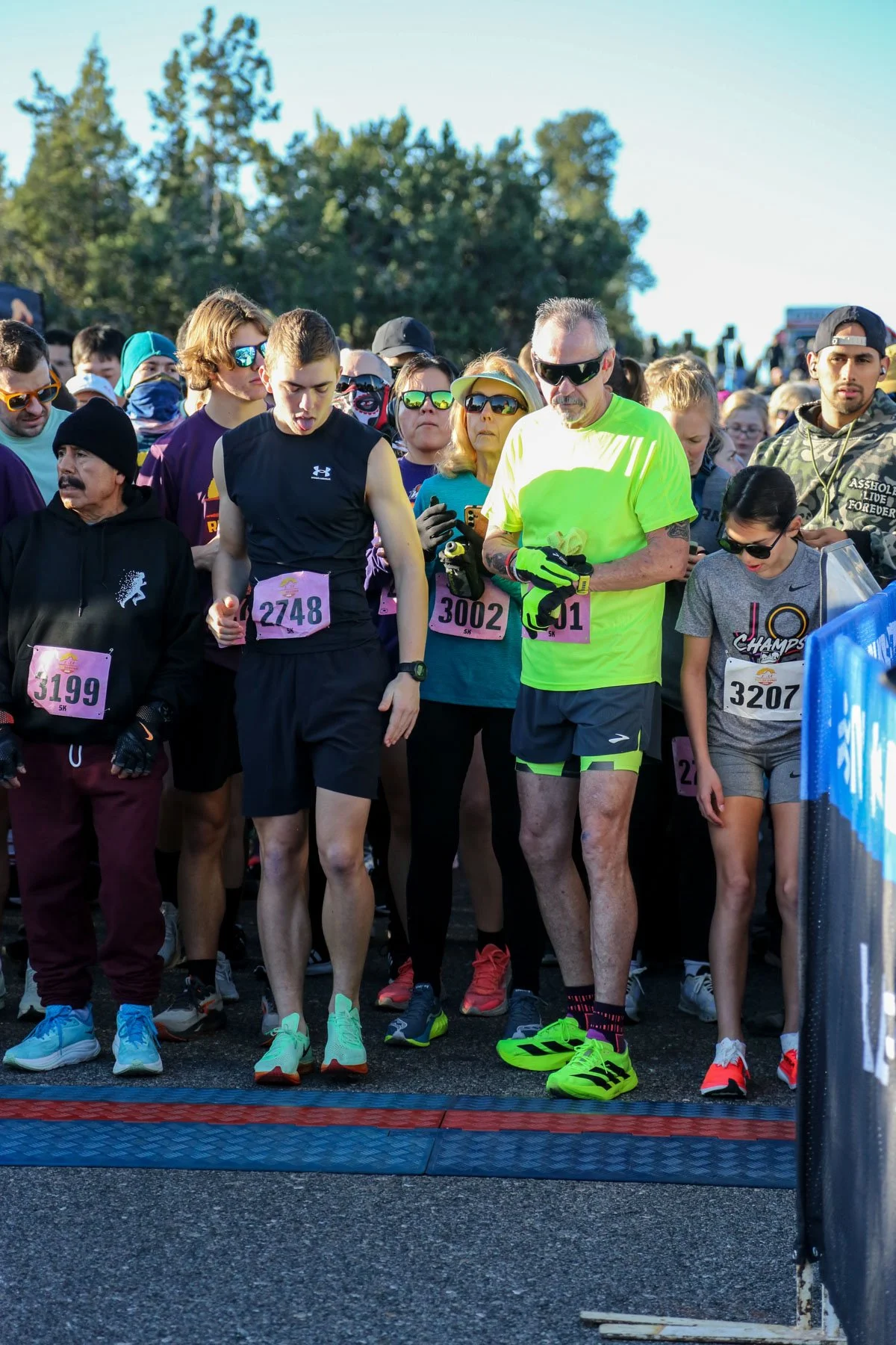 RunSedona 5K running event start line. Runners of all different ages and genders all are ready to go with hands on watches.