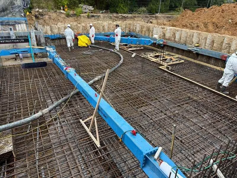 HYB Construction team installing concrete over formwork and reinforcement during slab construction in London.