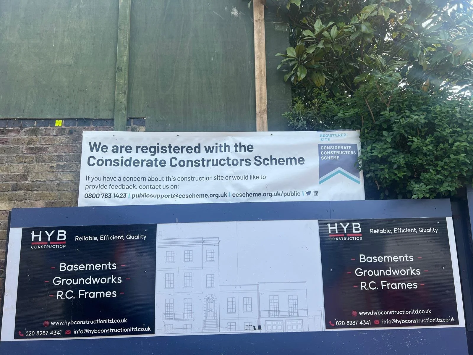 HYB Construction site signage displaying Basements, Groundworks and RC Frames services in London
