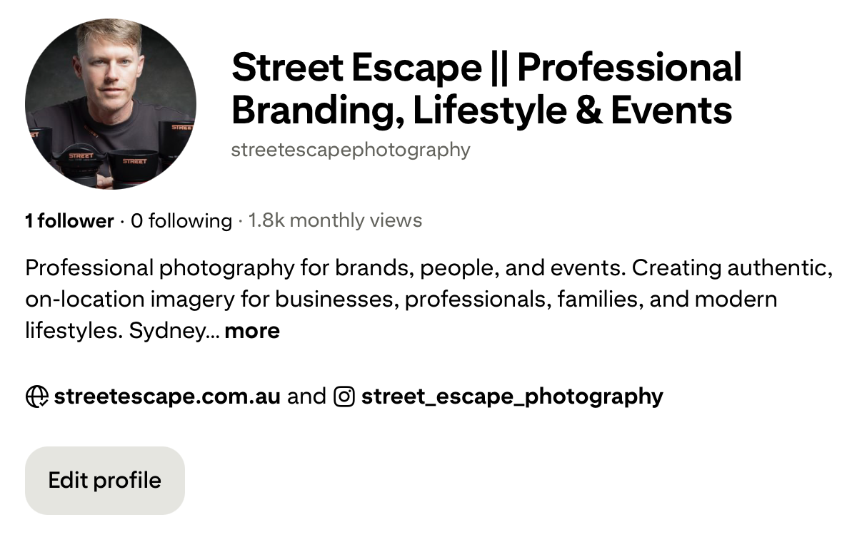 Profile picture of a man with blond hair wearing a black racing suit with orange accents, holding a cup, with a gray background.