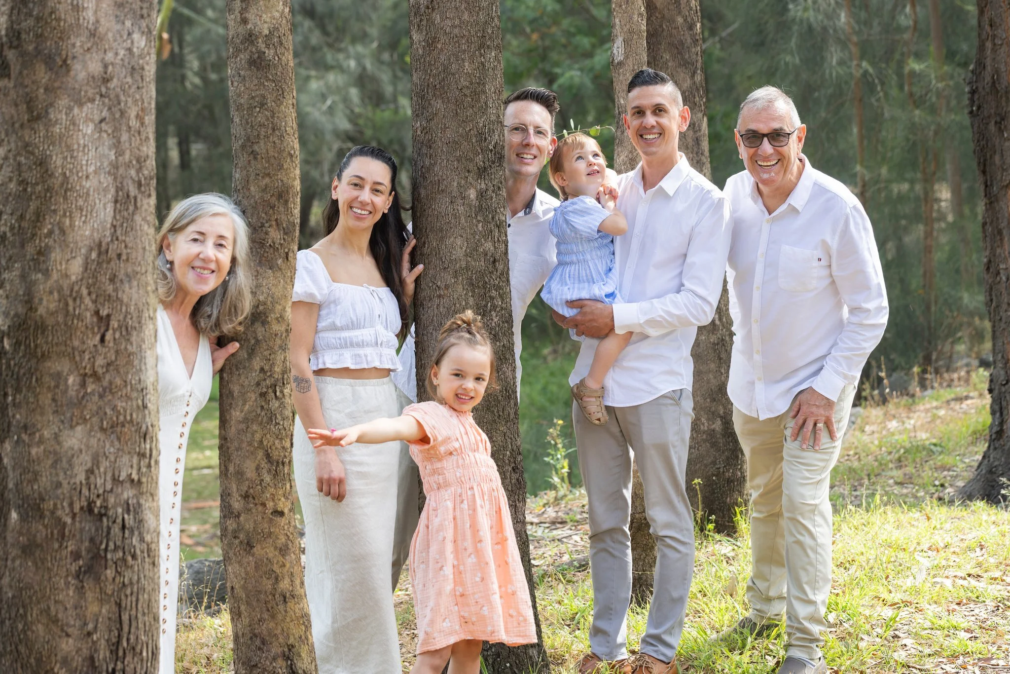 Candid family photo in between trees