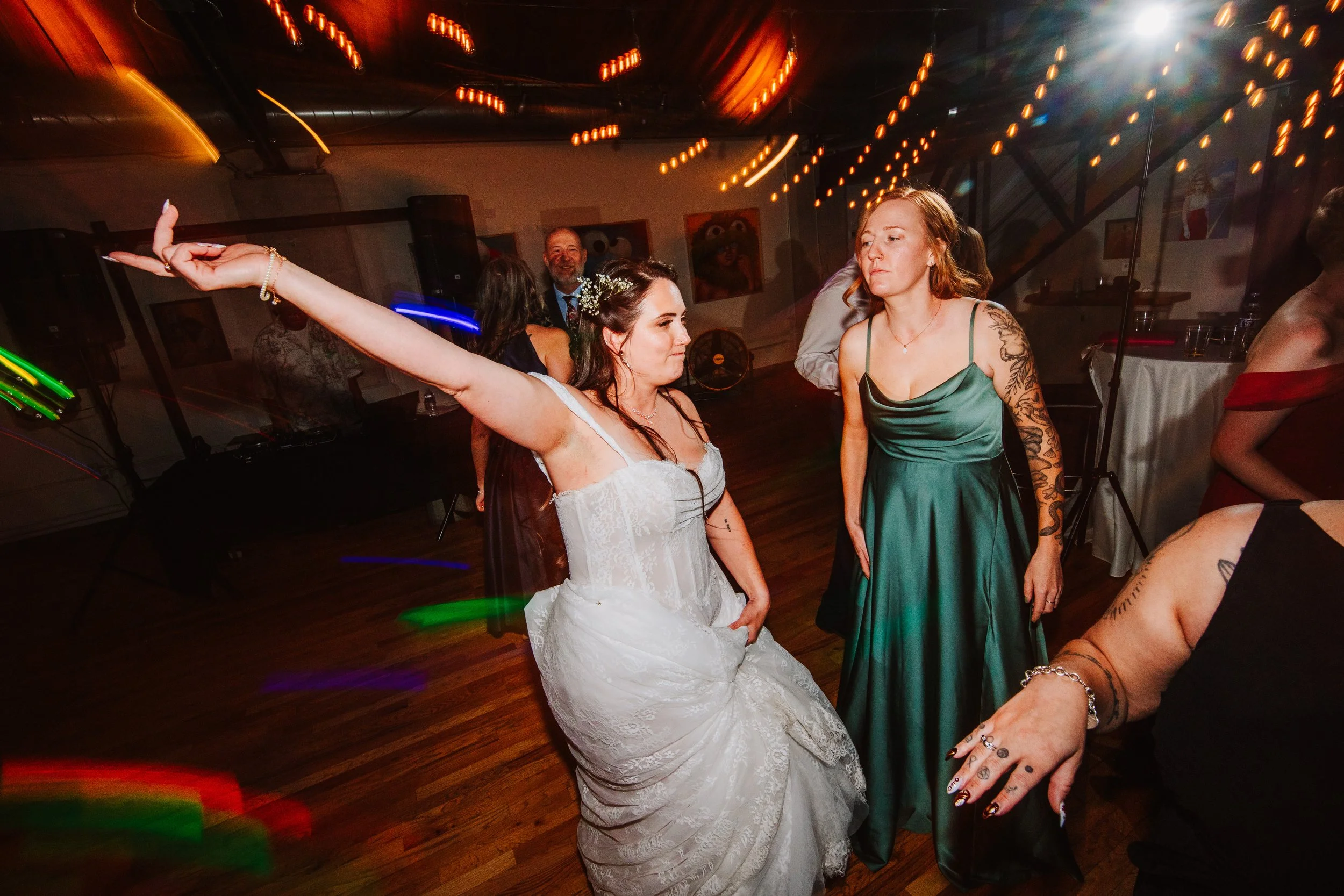 the bride throws her hands up 