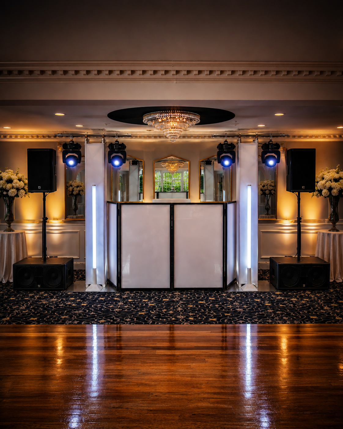 Event stage setup with Sound Active Events logo, featuring two large screens, vertical LED lights, and speakers in a venue with blue ambient lighting.