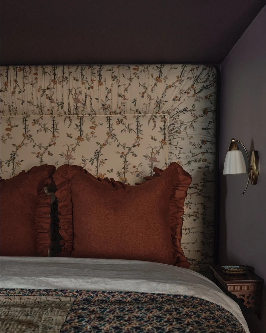 I loved this fabric for my client's attic guest room headboard, but it came in a standard width of 54", which wasn't wide enough for a queen bed frame, and I didn't want a seam. My solution was to create this exaggerated ruched border which ende