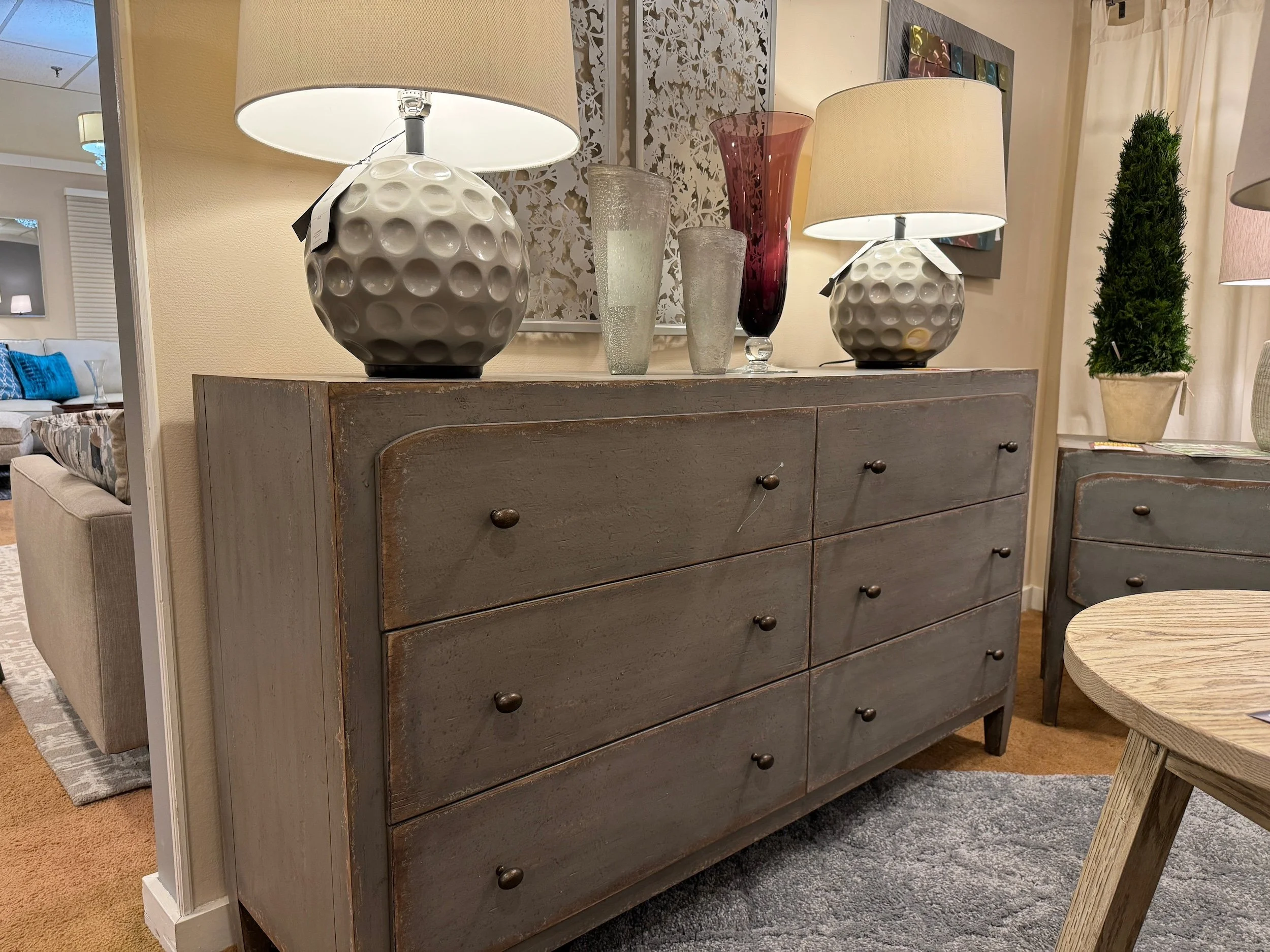Phot of gray distressed dresser. Are you looking for furniture stores in Anchorage? We offer high-quality furniture at an affordable price. Visit our showroom today!