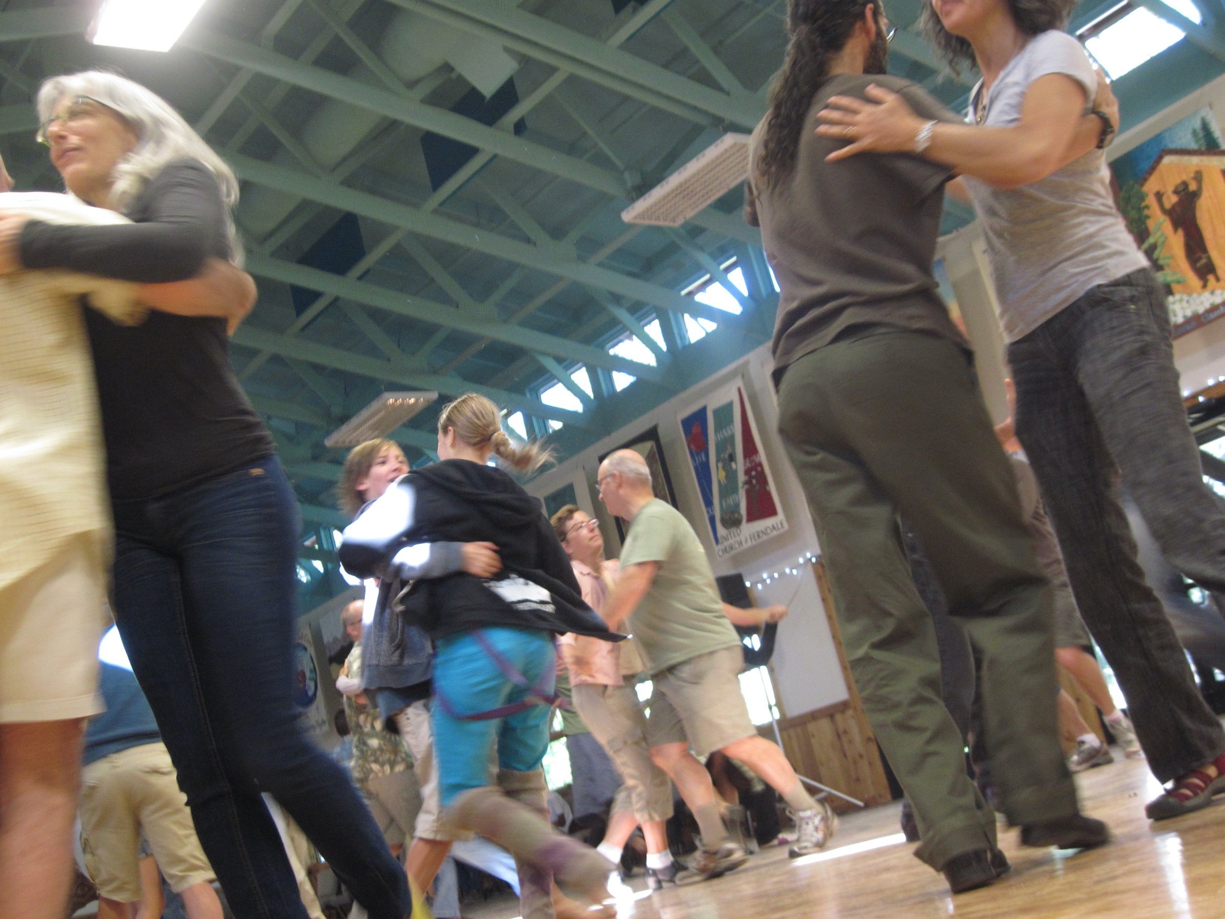 Dancers spinning each other round and round.