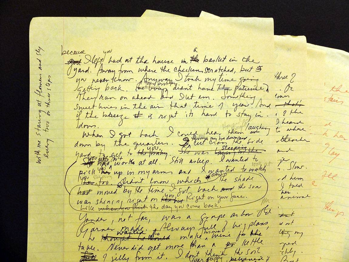 A yellow lined notebook page filled with handwritten notes and edits in black ink, with some red annotations on the edges.