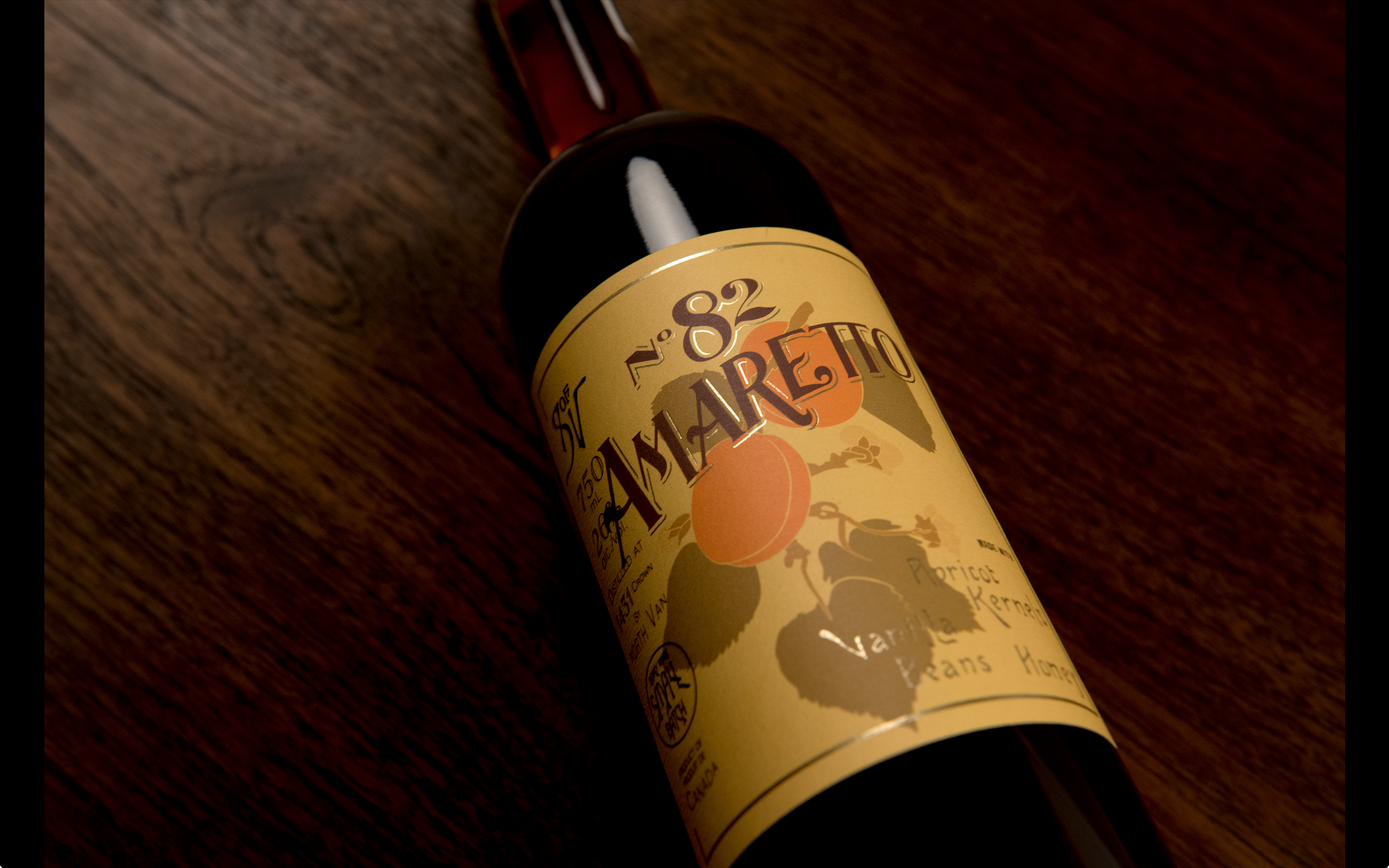 A bottle of amaretto lying on a wooden surface