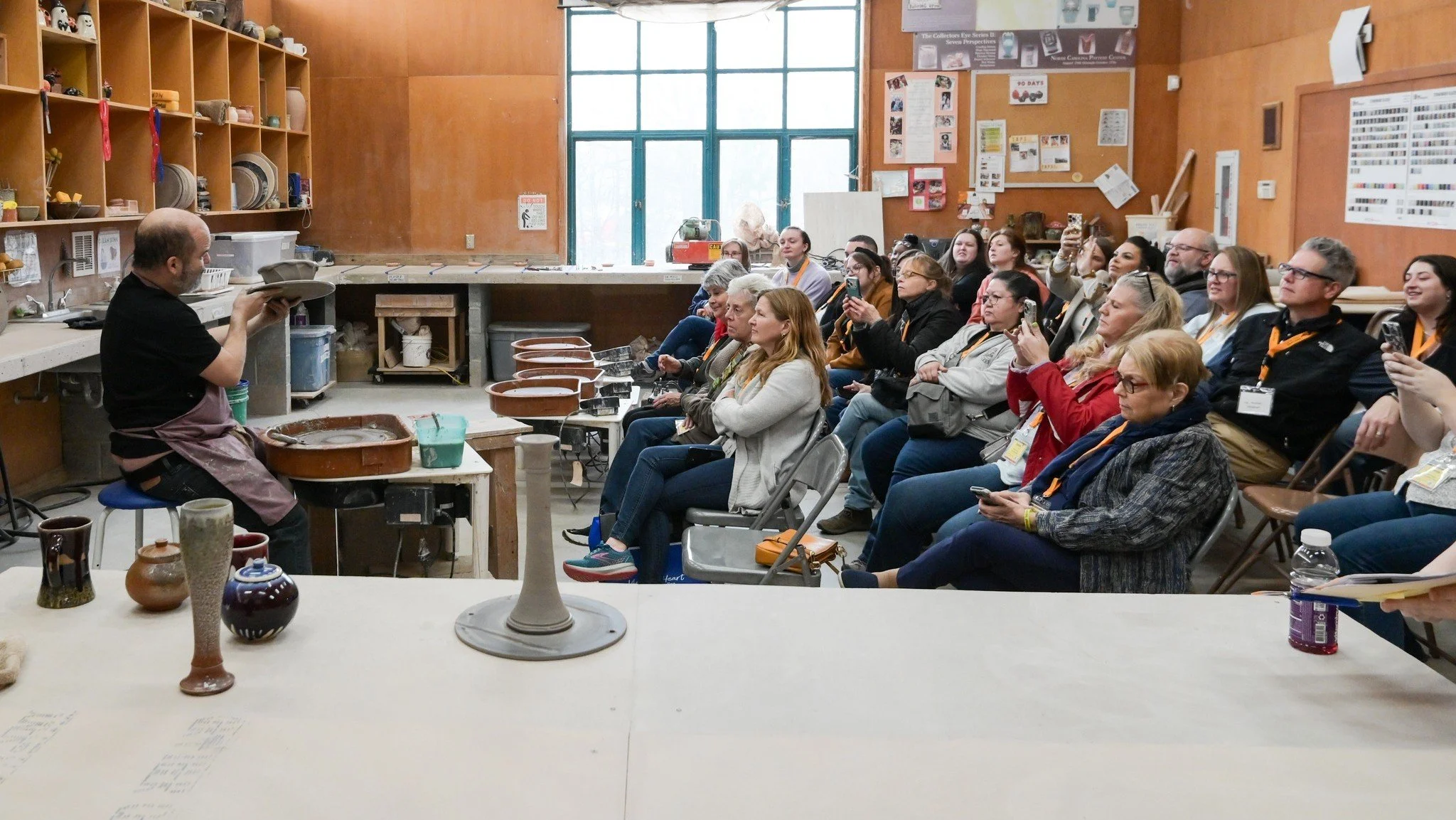 Group watching a pottery demonstration.