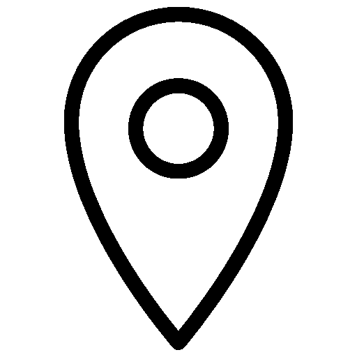 A person holding a smartphone in front of a circular mirror, taking a selfie.