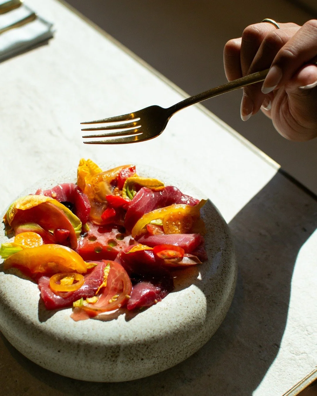 Kiss /kis/ (n.)
The lightest touch with the boldest intent.
Yellowfin, tomato, and berry&mdash;tender meets tart under a sprinkle of edible flowers.