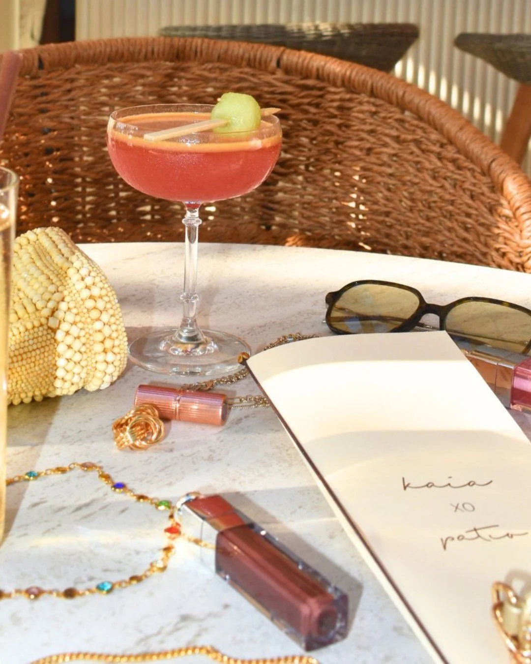 A collection of summer essentials: a chilled cocktail, good company, and nowhere to be.