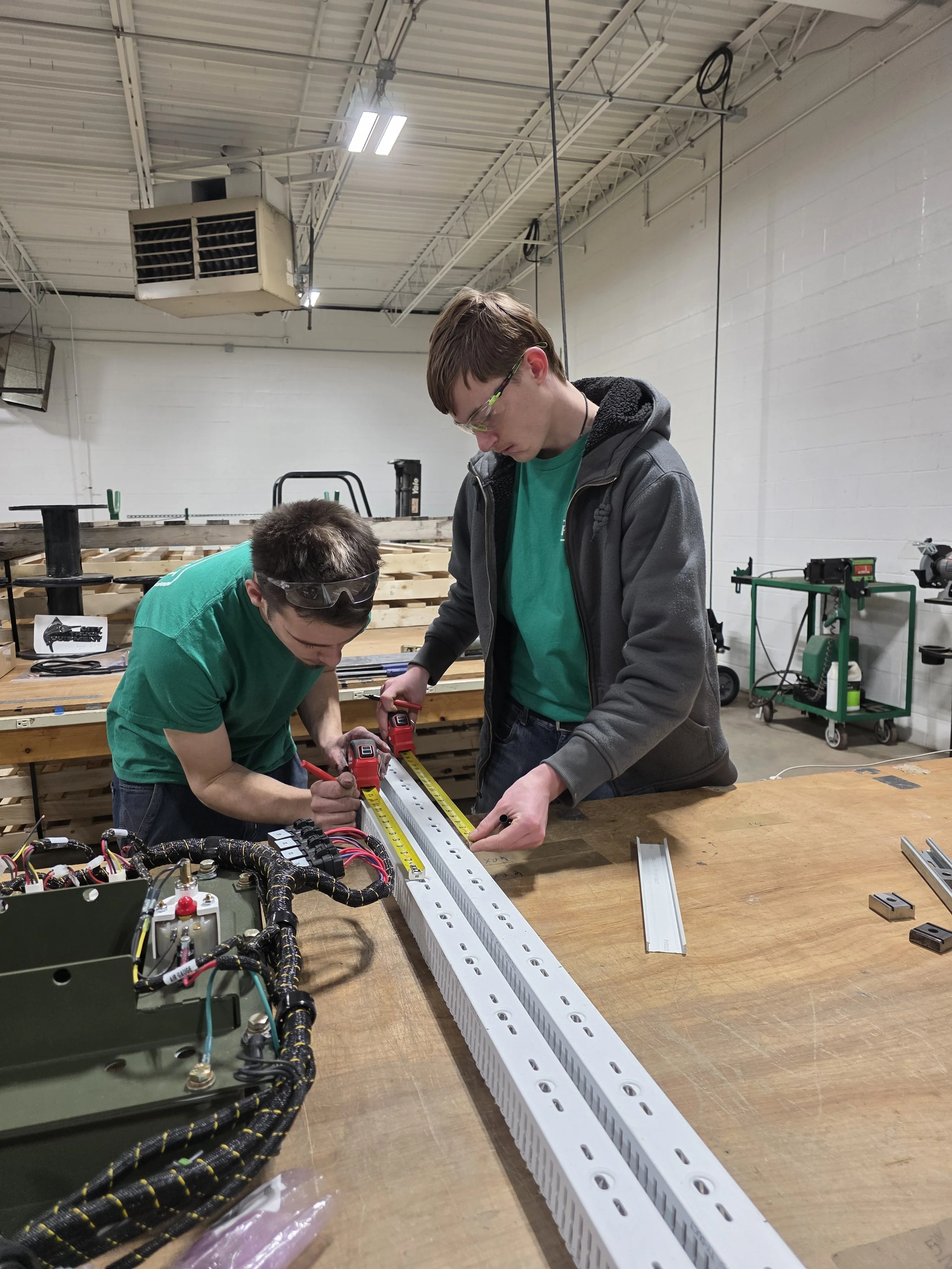 Northland CAPS engineering students apply technical and teamwork skills while measuring components during a hands-on industry-aligned project.