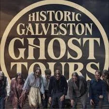 Group of people walking in front of a sign that reads 'Historic Galveston Ghost Tours'.