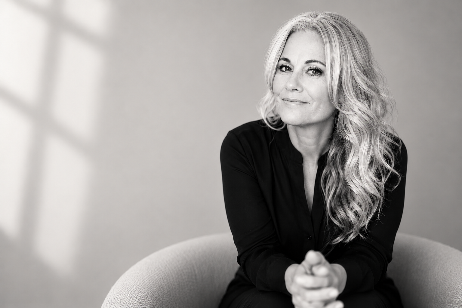 Christy Cunningham, founder of inCioX, seated in a black-and-white portrait
