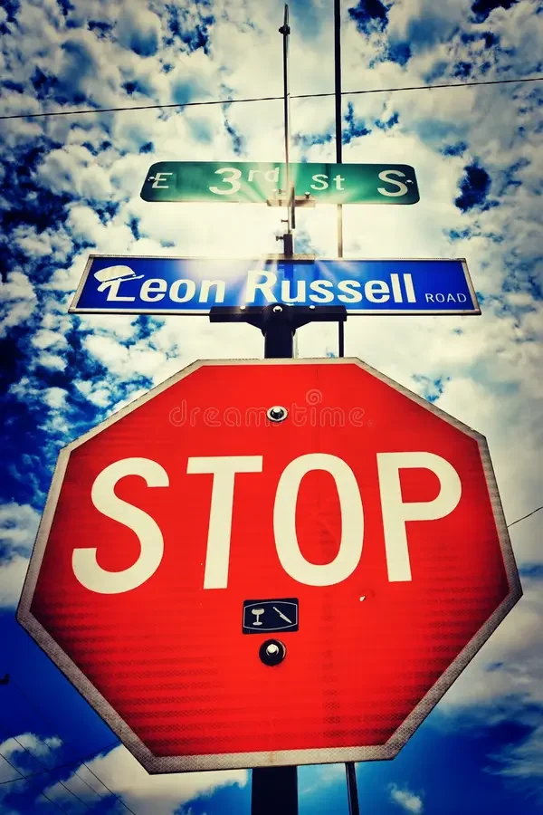rock-music-legend-leon-russell-s-road-above-stop-sign-clouds-sky-tulsa-icon-industry-finally-received-named-222490447.webp
