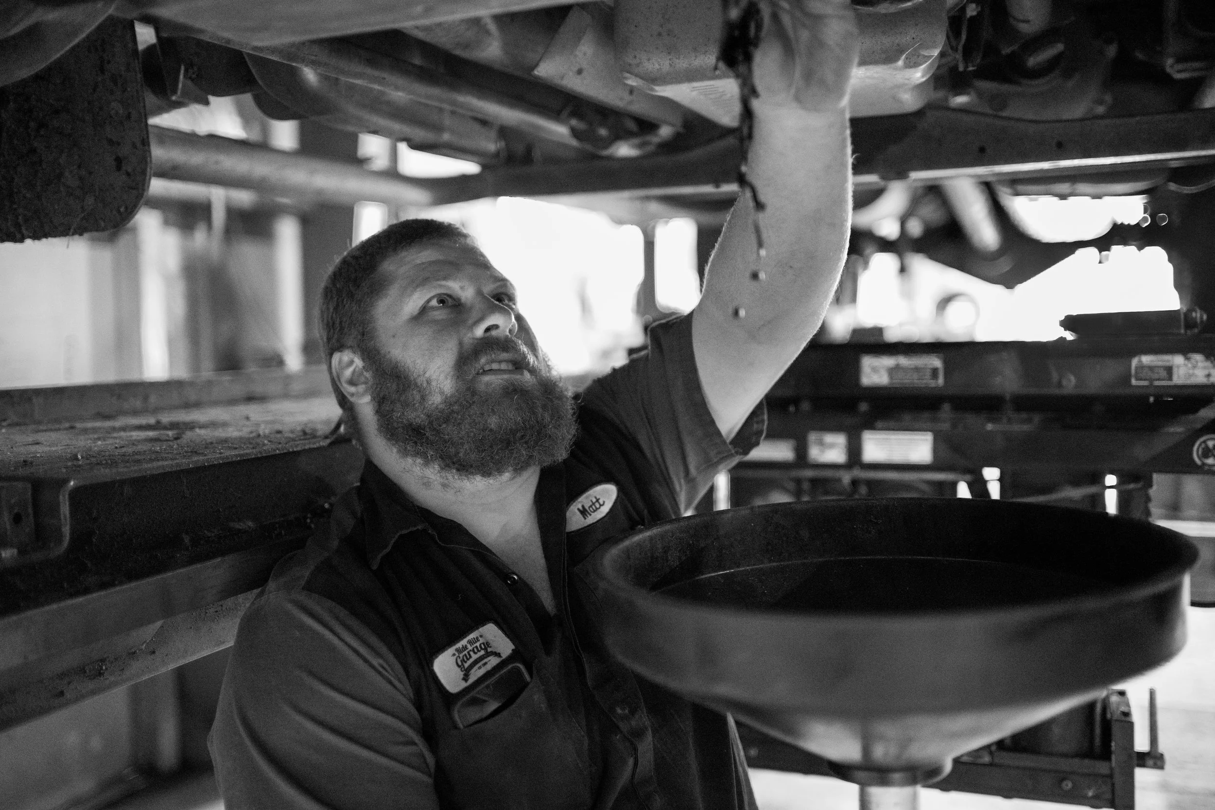 a large suv or truck sits on a lift for repair