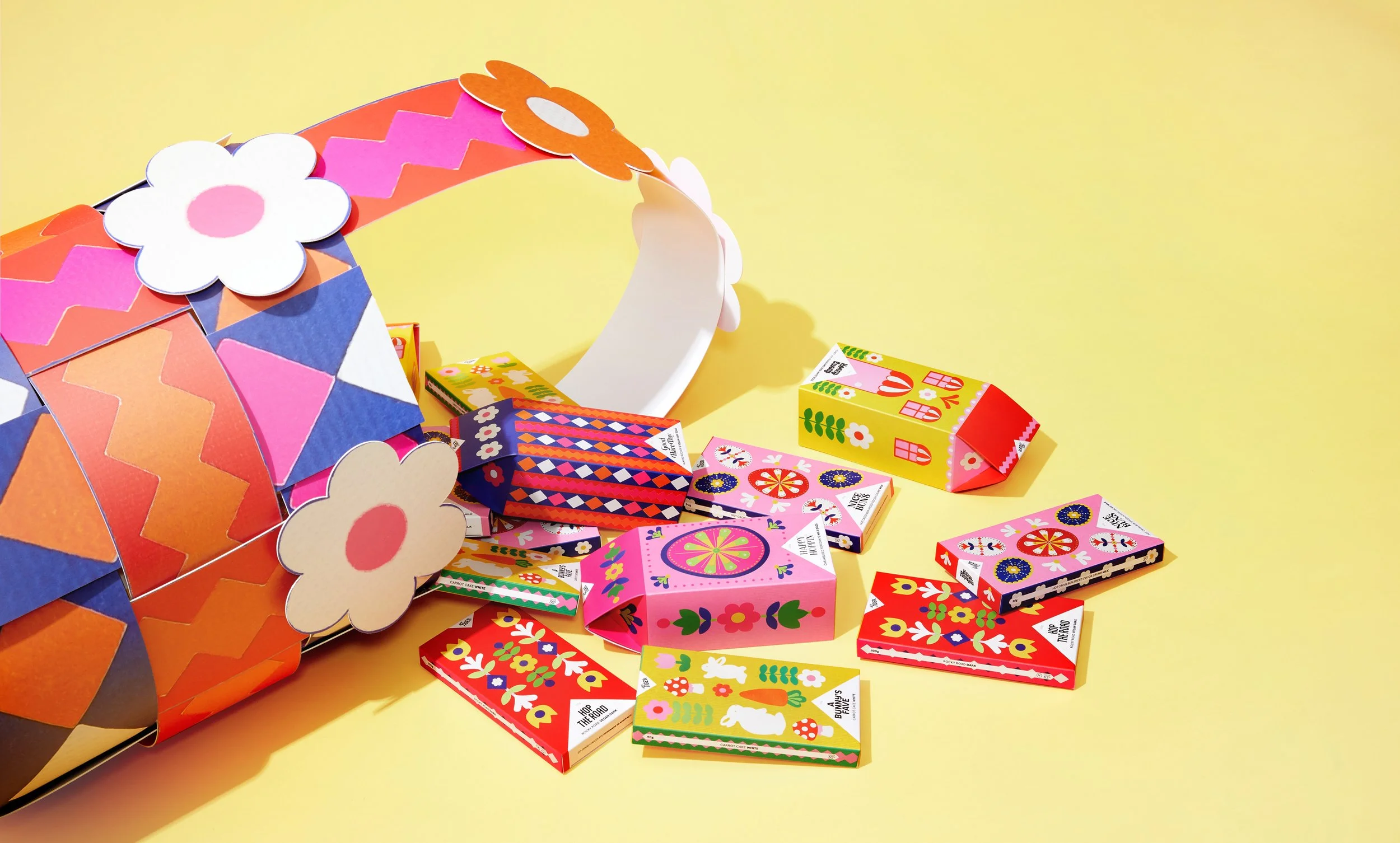 Colourful packaging design for a collection of chocolate bars, designed by Kitiya Palaskas and featuring folk art-inspired papercraft collage illustration in various Easter-themed motifs.