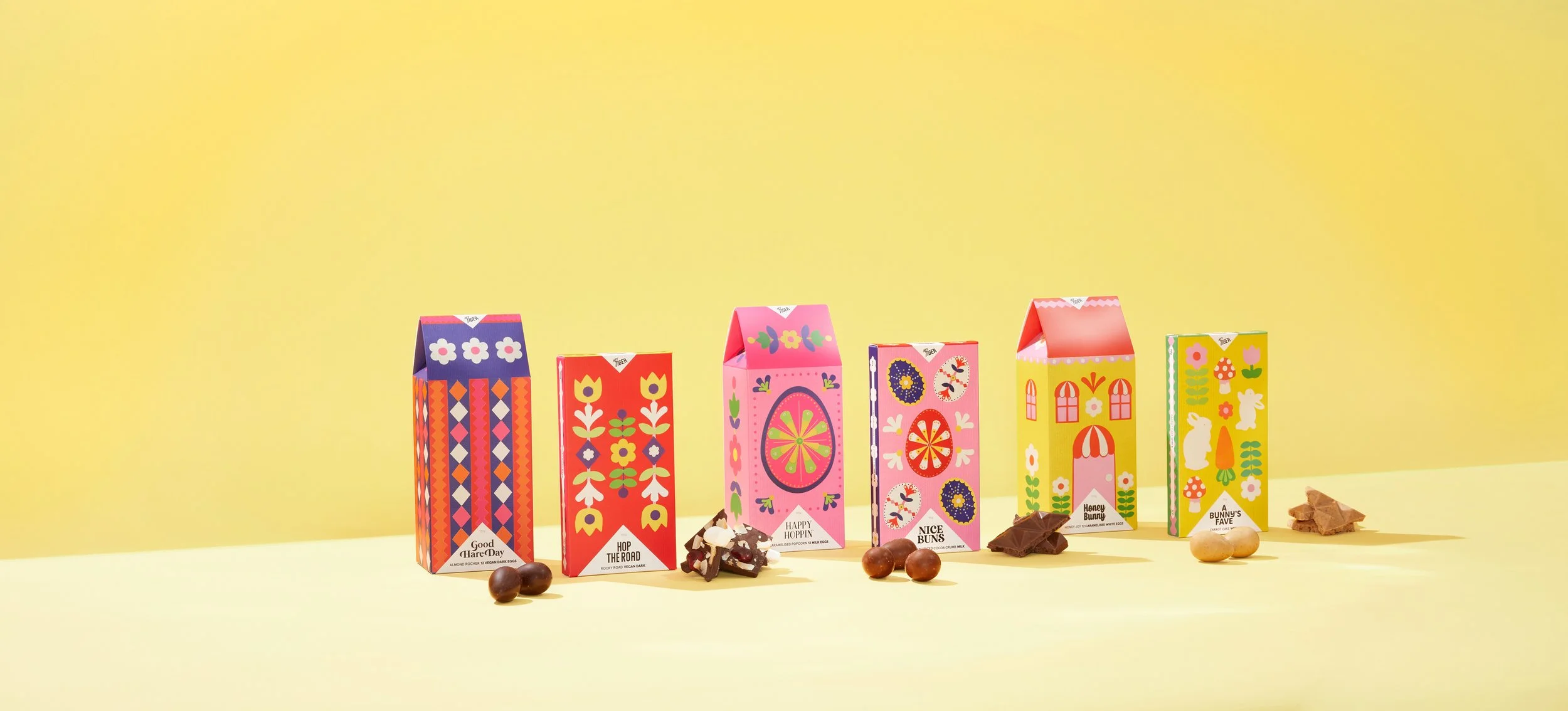 Colourful packaging design for a collection of chocolate bars, designed by Kitiya Palaskas and featuring folk art-inspired papercraft collage illustration in various Easter-themed motifs.