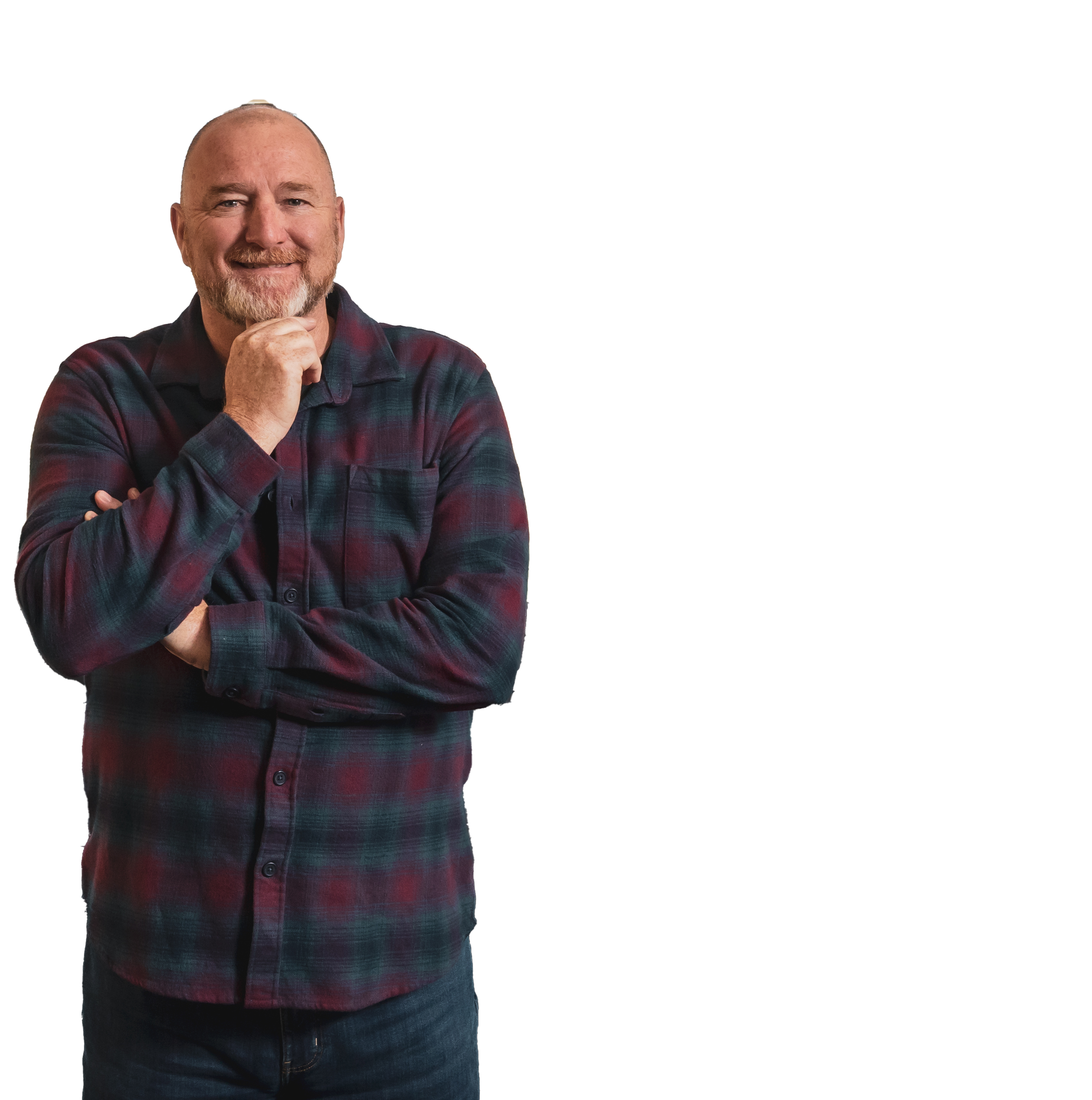 Man with beard and short hair wearing a plaid shirt, smiling with arms crossed.