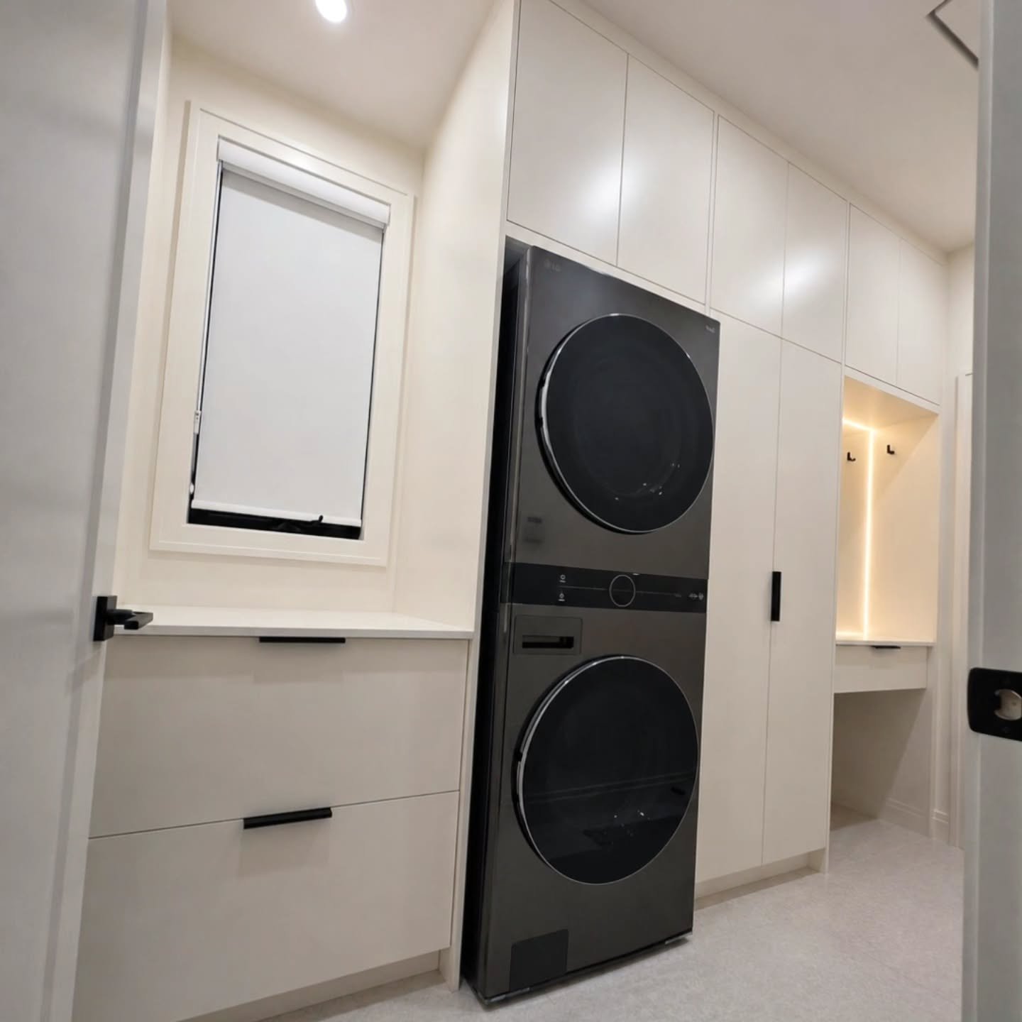 Modern laundry rooms should work as hard as they look.

Floor-to-ceiling cabinetry, integrated storage, and a dedicated drop zone come together to maximize every inch of this space.

Warm LED lighting adds depth and ambiance, while the seamless millw
