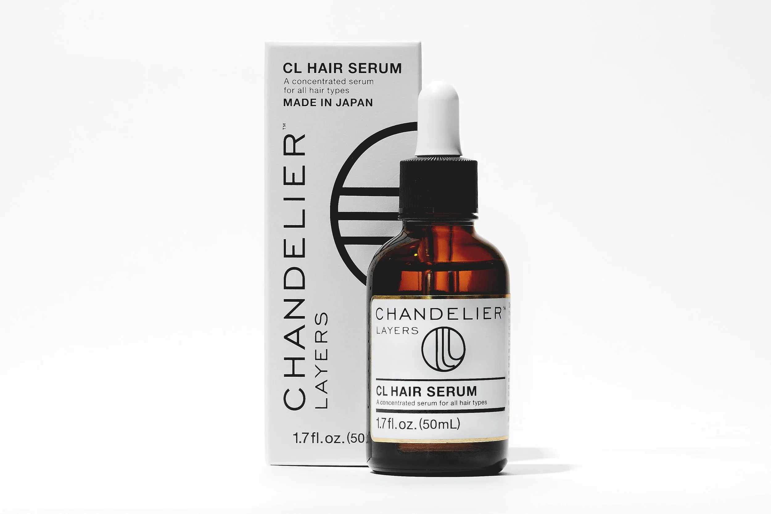 A bottle of CHANDELIER Layers CL Hair Serum with its packaging, featuring a white label with black text, an amber glass bottle, and a white dropper cap, placed against a white background.