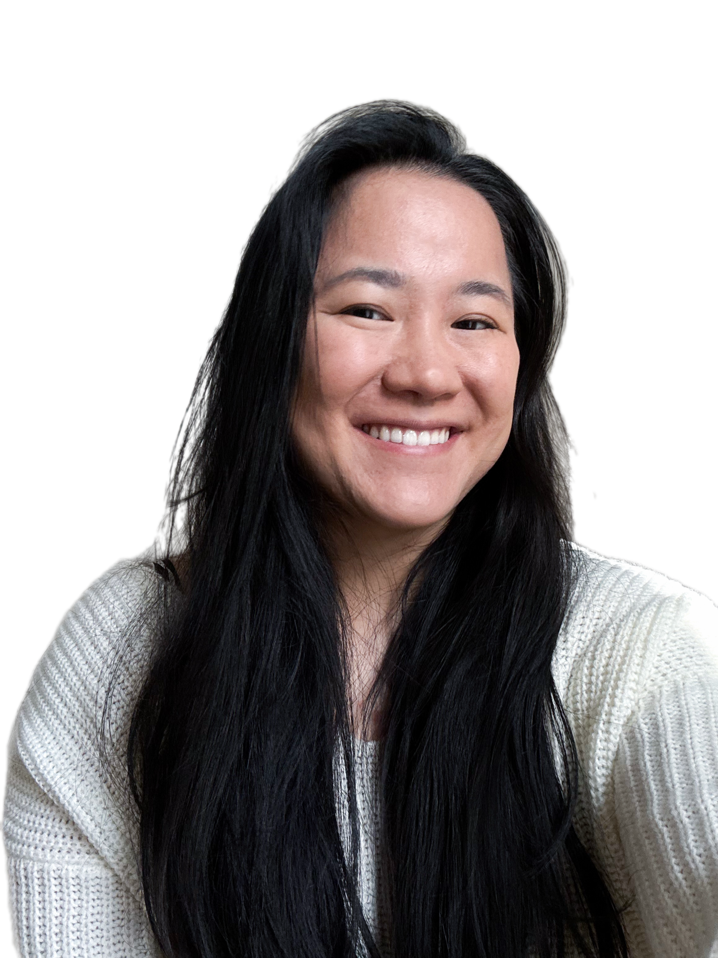 A woman with long black hair smiling, wearing a white knitted sweater.