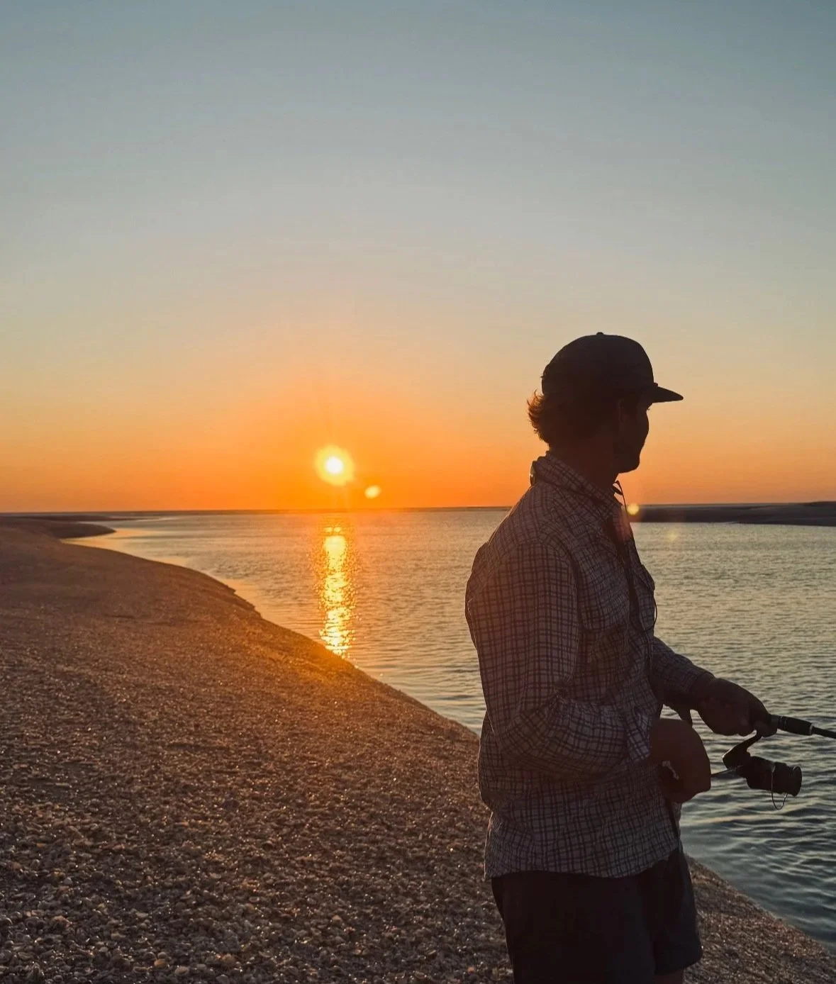 Fishing on sunset at beach.