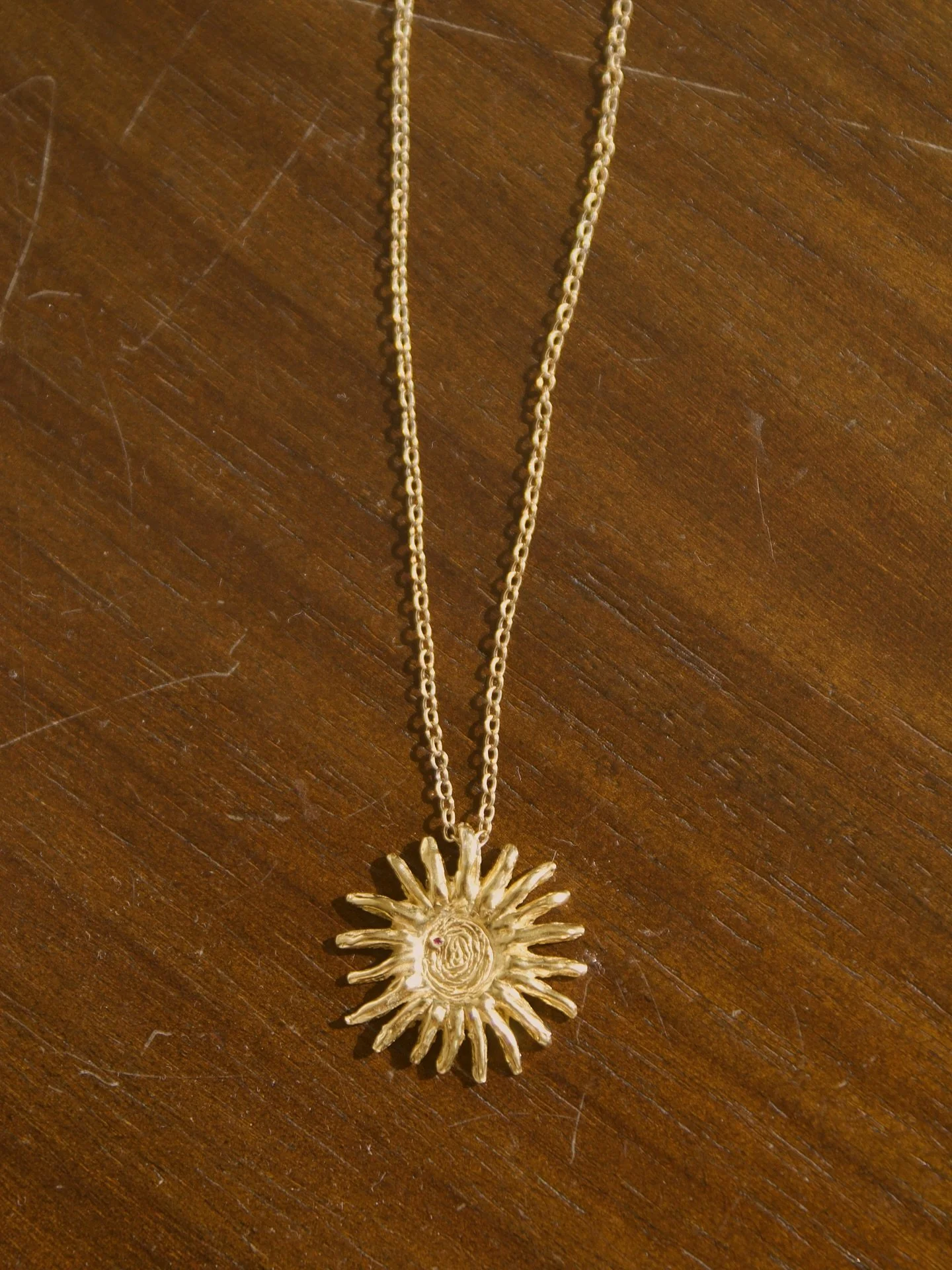 Radiance Necklace 
18kt gold plated sterling silver | 1mm lab ruby | hand sculpted using sterling silver metal clay 
#jewelry #goldjewelry #faithbased #handmadejewelry #silverclay #sunnecklace #metalclay #necklace