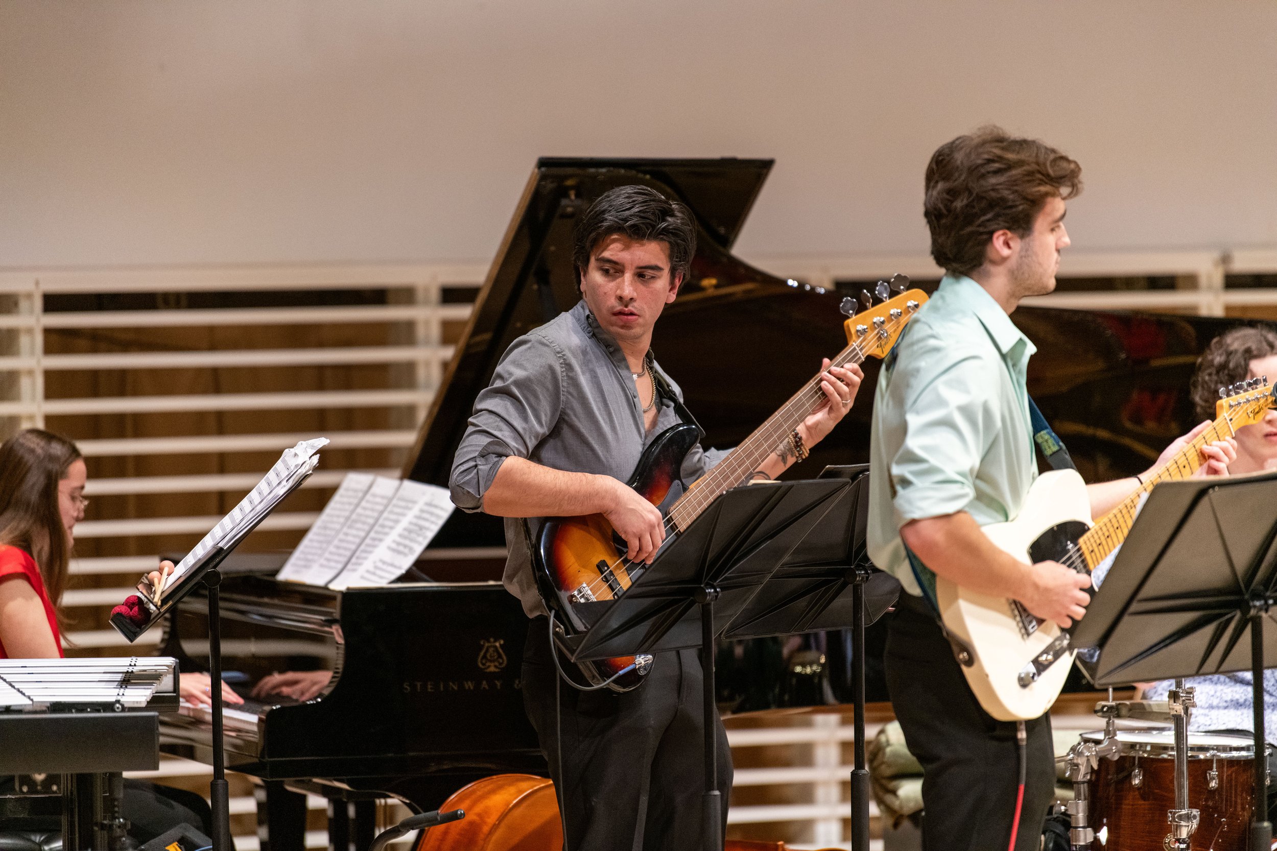 A bassist on the Centre Dimensions ensemble plays the electric bass during the concert in the Recital Hall on Wednesday, Nov. 13, 2024 in University Park, Pa.