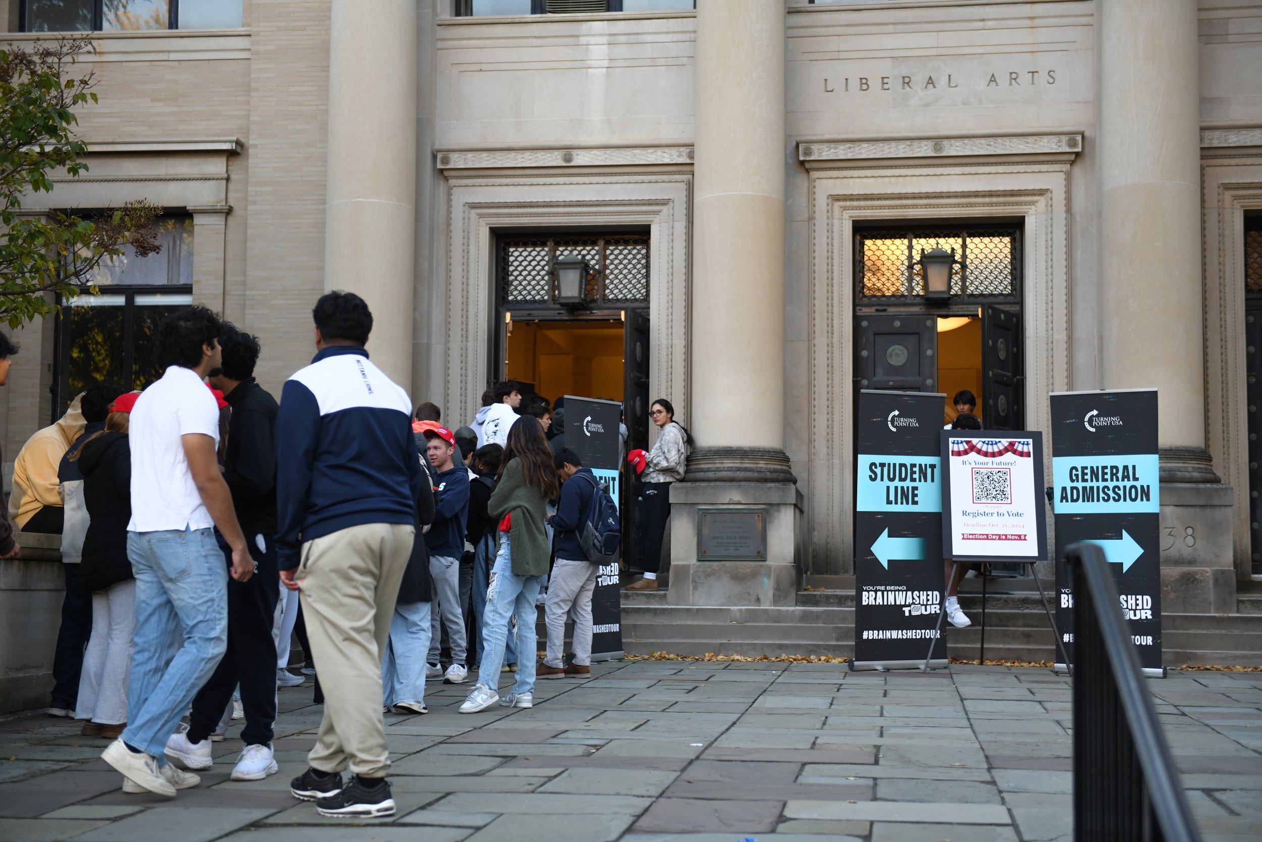 Penn State students queue up outside the Sparks Building to watch the "You're Being Brainwashed" tour hosted by Penn State's chapter of Turning Point USA on Thursday, Oct. 17, 2024, in University Park, Pa.