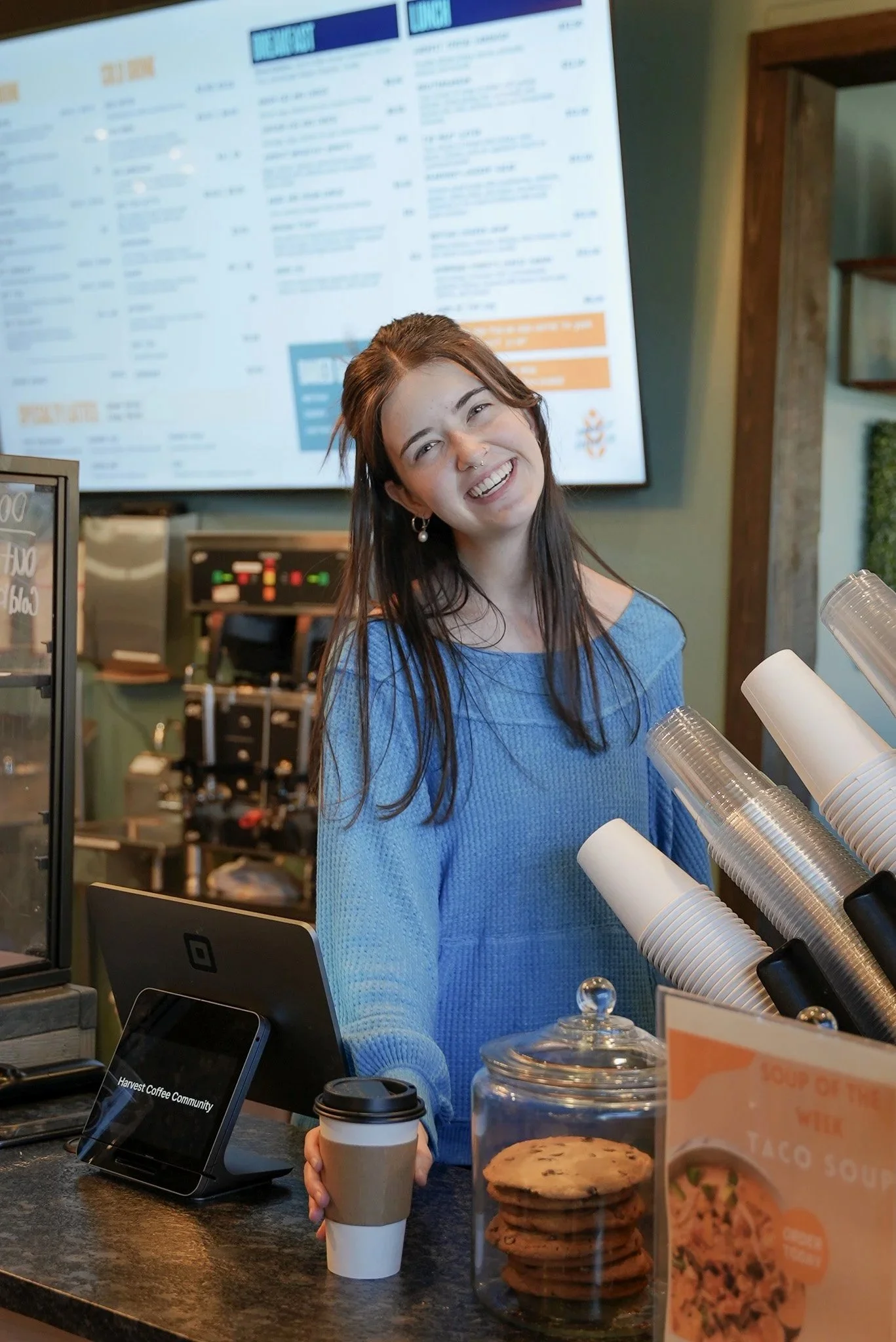 barista serving specialty coffee at harvest coffee co in Columbus GA