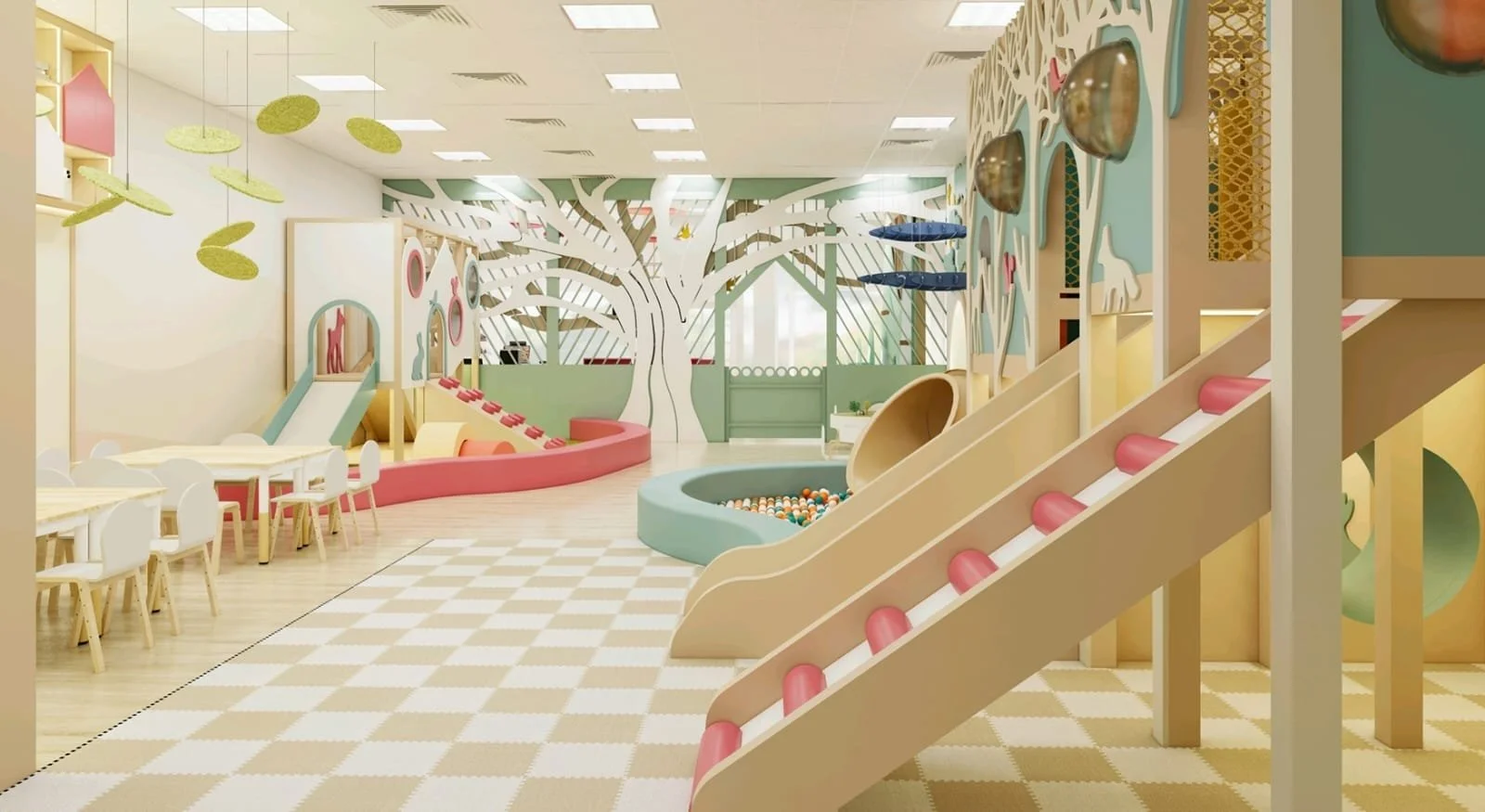 Wide-angle view of the indoor play café, showcasing the toddler area, ball pit, slides, and seating. The open layout encourages parents to watch children while enjoying the café.
