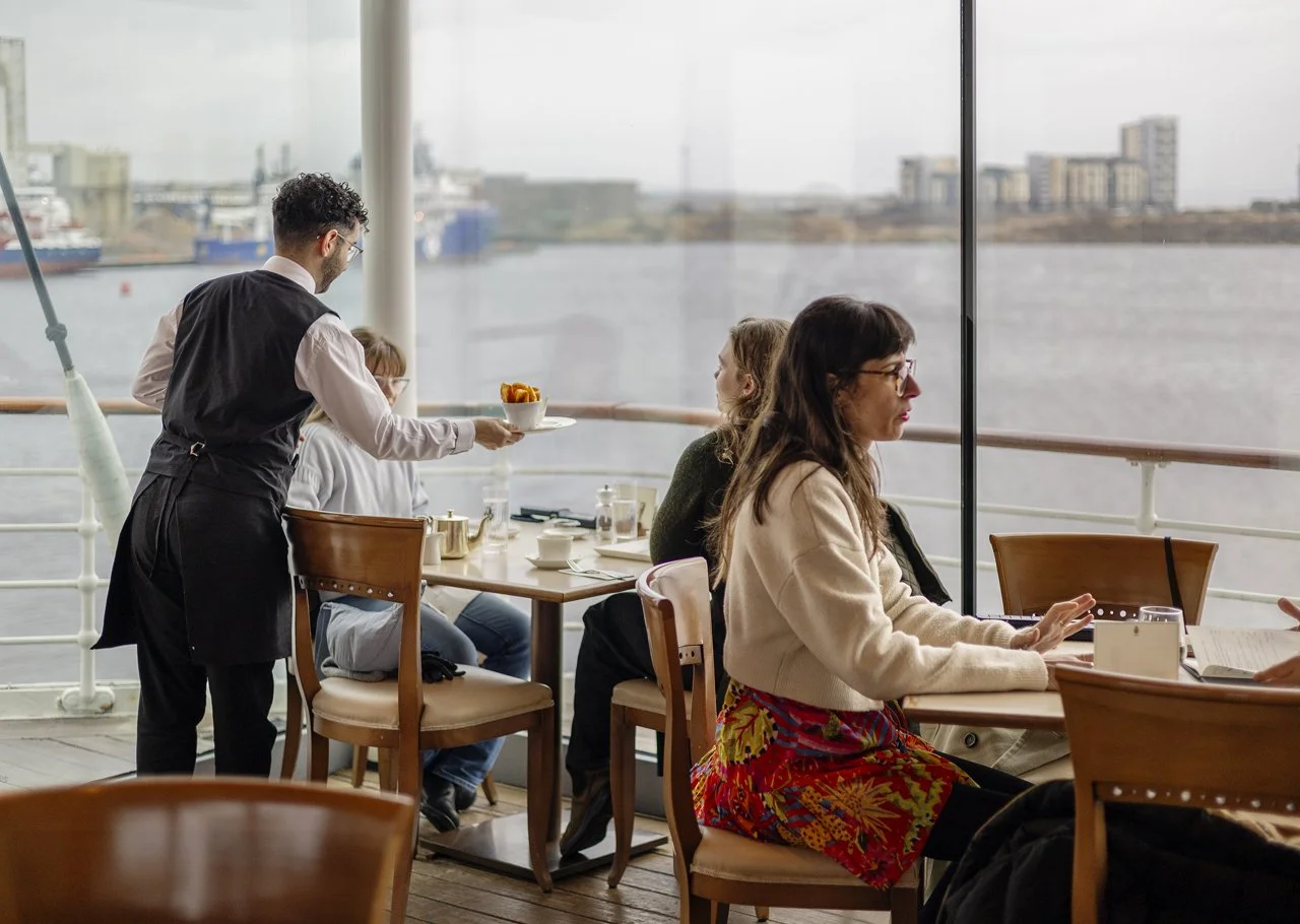 5-rameen-hospitality-server-serving-a-bowl-of-wedges-to-guests-in-the-tearoom.jpg