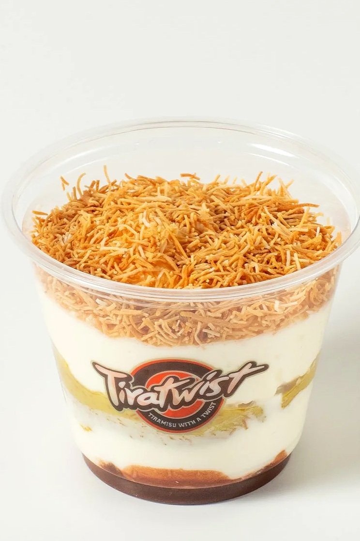 Tira Twist dessert with shredded toasted topping, creamy layers, and chocolate base in a clear plastic cup
