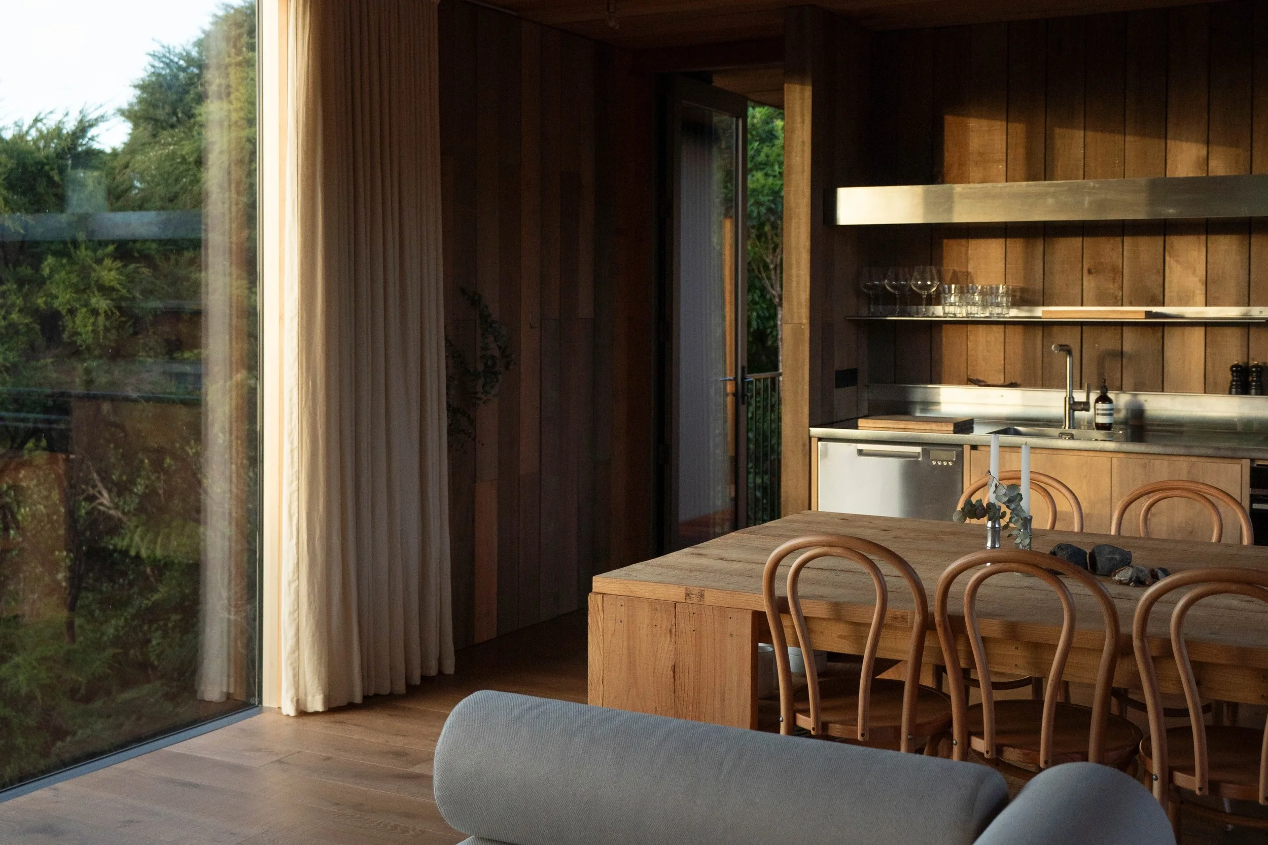 Awha at Ula Stays — boutique wooden retreat nestled in native bush overlooking Tutukaka Marina, New Zealand.