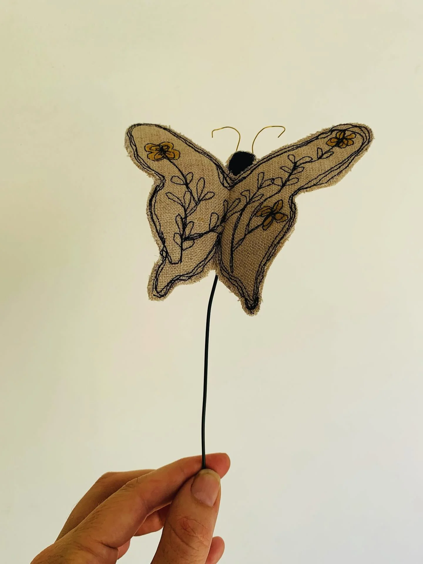 Guiding the fabric like a paintbrush under the sewing machine needle, letting instinct and movement breathe life into each wing.