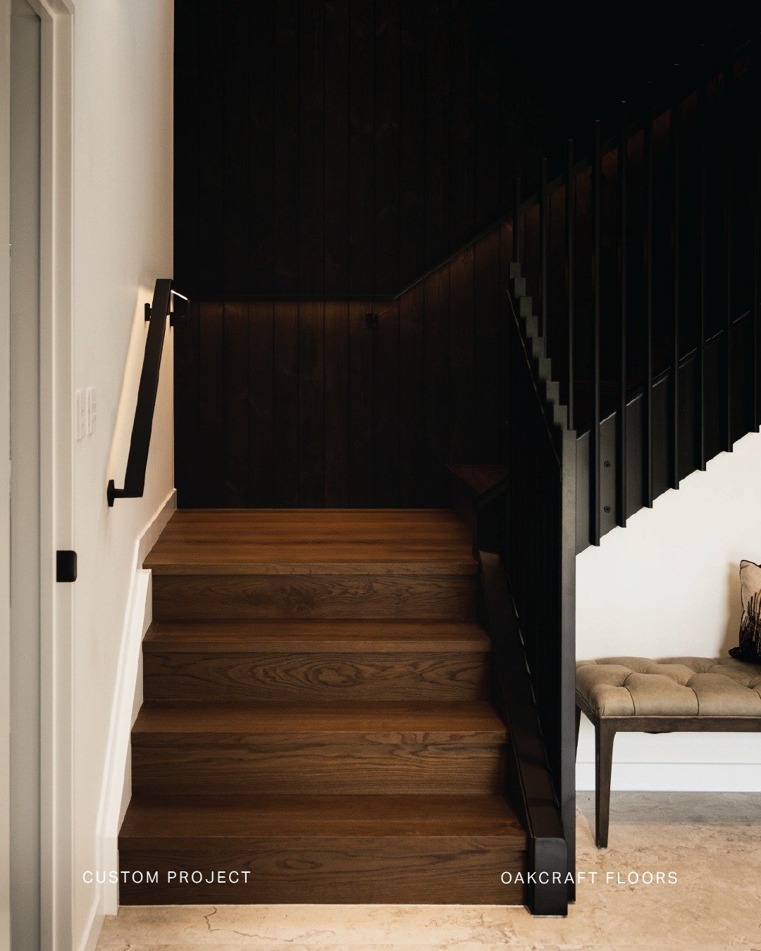 Where craftsmanship meets form and function.

Customised architectural stairs are framed by dark stained cedar wall panelling where every line is designed to flow with intention. Clean-lined balustrade and handrail complete the composition, enhancing
